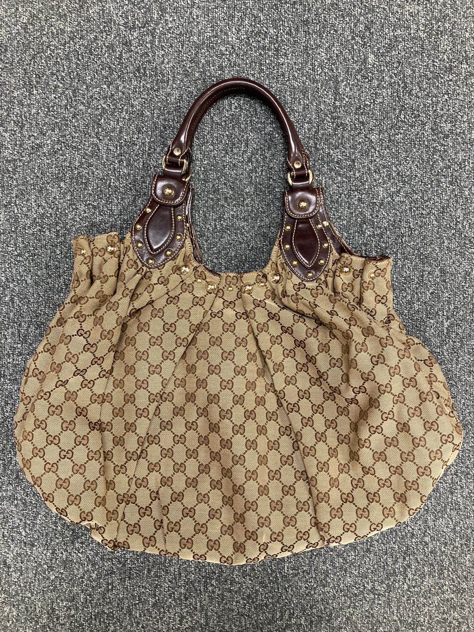 Gucci Pelham GG canvas y tachuelas